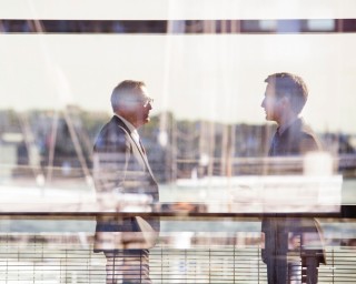 Company Management, A modern office building. Three people are talking to each other.
