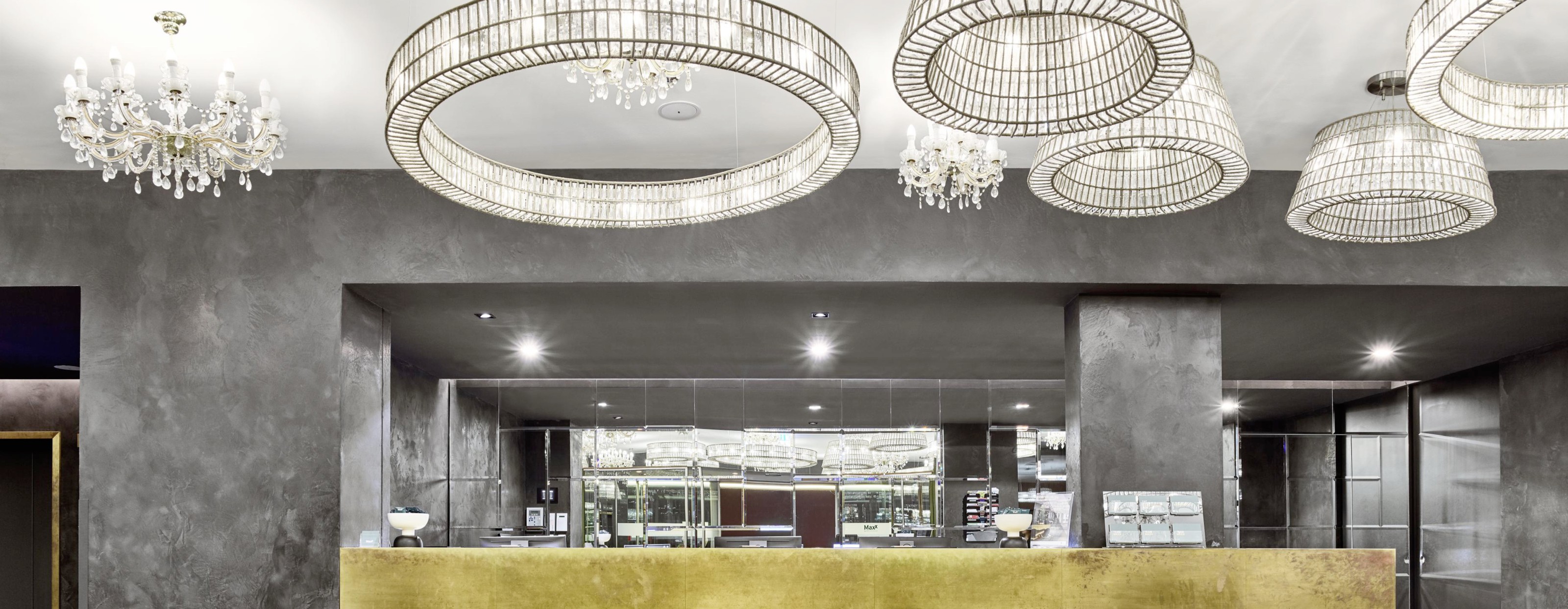 Reception area with modern chandeliers in a MAXX Hotel