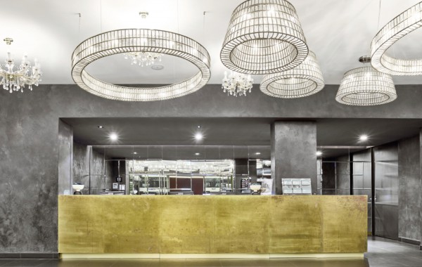 Reception area with modern chandeliers in a MAXX Hotel