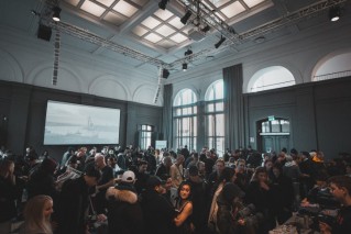 A crowd of people in a large auditorium.