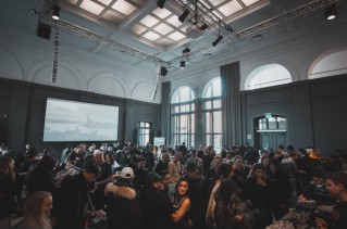A crowd of people in a large auditorium.