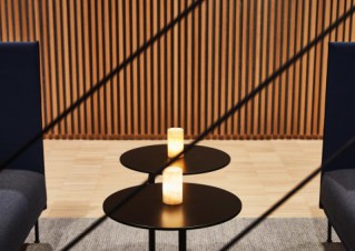 detail shot of a small, round coffee table between two couches.